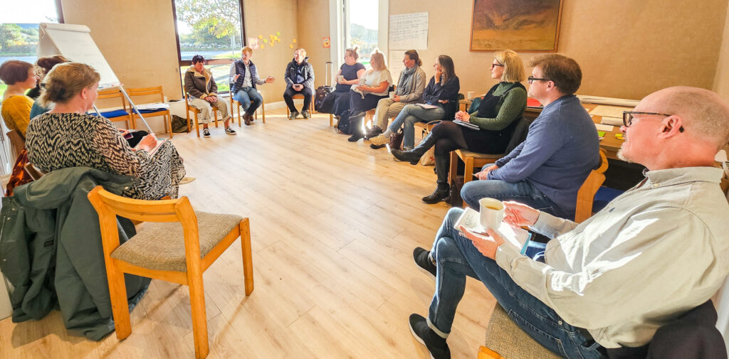 Photo of a group of people sitting in a sircle